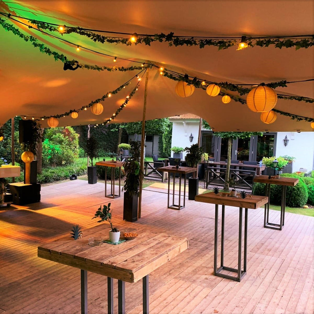 Indoor showroom display featuring a stretch tent setup with lighting and furniture