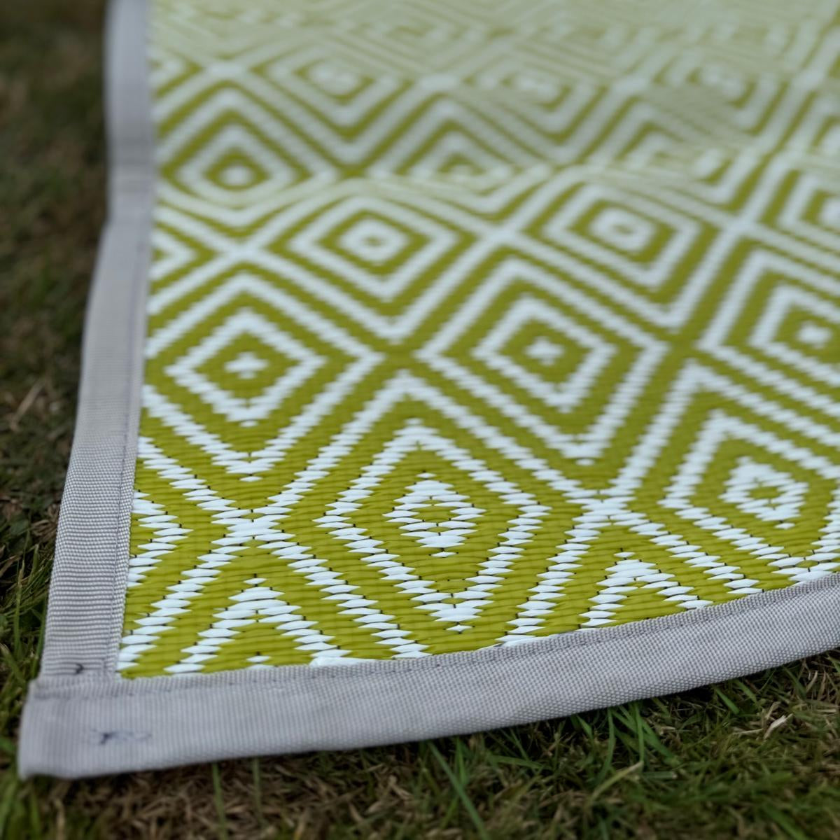 Green diamond-pattern flooring showing round cut corner and woven polypropylene detail