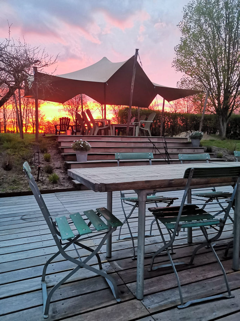 Outdoor stretch tent seating area at sunset
